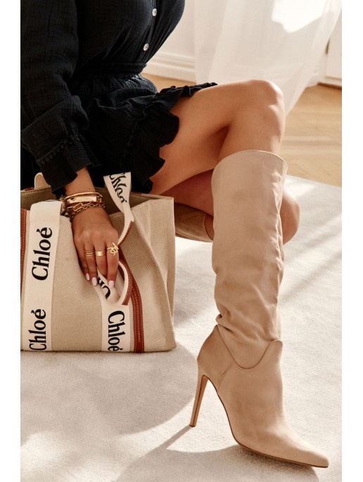 Classic Suede Black Boots On A Beige Ameya